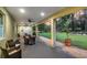 Covered patio with outdoor seating and views of the expansive lawn with fire pit at 242 Cheyenne Rd, Summerville, SC 29483