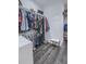 Well-organized walk-in closet with ample hanging space, shelving and hardwood floors at 242 Cheyenne Rd, Summerville, SC 29483