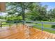 A spacious back deck provides outdoor space with wooden flooring overlooking a lush backyard at 245 Lake Dr, Summerville, SC 29483
