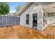 A bright and airy covered back porch with wood flooring provides a relaxing outdoor space at 245 Lake Dr, Summerville, SC 29483