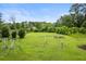 A spacious backyard with a swing set set and lush greenery is a perfect space for outdoor activities at 245 Lake Dr, Summerville, SC 29483