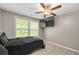 This bedroom is complete with a ceiling fan, window, and a black bedspread at 245 Lake Dr, Summerville, SC 29483