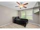 Cozy bedroom features a ceiling fan, window, and stylish bed with a black bedspread at 245 Lake Dr, Summerville, SC 29483