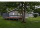 Charming home featuring a cozy deck, gray siding, and a well-maintained lawn with mature trees at 245 Lake Dr, Summerville, SC 29483
