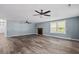 Spacious living room with light-filled windows, ceiling fan, and a cozy decorative fireplace at 245 Lake Dr, Summerville, SC 29483
