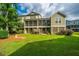 Lush backyard with green grass, a well-maintained lawn, and a view of the back exterior of the home at 246 Slipper Shell Ct, Mount Pleasant, SC 29464