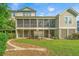 Spacious backyard featuring a screened porch on two levels, with a well-maintained lawn and mulched areas at 246 Slipper Shell Ct, Mount Pleasant, SC 29464