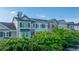 Exterior view of townhomes featuring hardiplank siding and brick accents with black shutters at 246 Slipper Shell Ct, Mount Pleasant, SC 29464