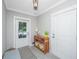 Inviting foyer with neutral tones, a stylish table with baskets, and an exterior view of the neighborhood at 246 Slipper Shell Ct, Mount Pleasant, SC 29464