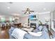 Bright living room with a fireplace, hardwood floors, and a seamless transition to the dining area and kitchen at 246 Slipper Shell Ct, Mount Pleasant, SC 29464