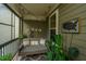 Cozy screened porch with a swing, string lights, and lush greenery creating a peaceful retreat at 246 Slipper Shell Ct, Mount Pleasant, SC 29464