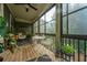 Relaxing screened porch with comfortable seating, a ceiling fan, and views of the surrounding greenery at 246 Slipper Shell Ct, Mount Pleasant, SC 29464