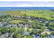 Wide aerial shot reveals the property's proximity to the ocean, golf course, and neighboring houses at 261 Palm St, Mount Pleasant, SC 29464