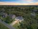 Aerial view of a beautiful house in a waterfront community with lush trees and distant water views at 261 Palm St, Mount Pleasant, SC 29464