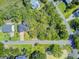 Aerial view capturing the home's location within a neighborhood surrounded by mature trees and a quiet street at 261 Palm St, Mount Pleasant, SC 29464