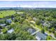 A scenic aerial view showcases a bridge, lush trees, and a neighborhood in a coastal setting at 261 Palm St, Mount Pleasant, SC 29464