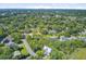 An aerial view shows a neighborhood filled with lush trees and well-maintained homes at 261 Palm St, Mount Pleasant, SC 29464