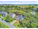 Aerial view of home with landscaping, garage, and surrounding neighborhood close to ocean inlet and golf course at 261 Palm St, Mount Pleasant, SC 29464