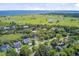 Expansive aerial view of a lush, green golf course with waterfront homes under a bright blue sky at 261 Palm St, Mount Pleasant, SC 29464