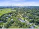A scenic aerial view showcases a bridge, lush trees, and a neighborhood in a coastal setting at 261 Palm St, Mount Pleasant, SC 29464