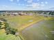 Aerial view showcasing the beautiful marshland, boardwalk, and nearby town with waterfront access at 261 Palm St, Mount Pleasant, SC 29464