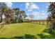 Spacious backyard featuring lush grass, privacy fencing, and views of the marsh at 261 Palm St, Mount Pleasant, SC 29464