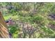 Tranquil backyard with well-maintained lawn, garden, and mature trees with a small chair nearby at 261 Palm St, Mount Pleasant, SC 29464