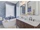 Stylish bathroom featuring a soaking tub, double vanity, and elegant tile work at 261 Palm St, Mount Pleasant, SC 29464