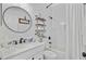 Well-lit bathroom with a vanity, shelving, and a bathtub with shower at 261 Palm St, Mount Pleasant, SC 29464