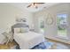 Inviting bedroom with a bed, side tables, and a ceiling fan at 261 Palm St, Mount Pleasant, SC 29464
