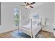 Bright bedroom with large window, ceiling fan, and a comfy bed at 261 Palm St, Mount Pleasant, SC 29464