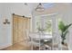 Bright dining area with a round table, ample windows, and sliding barn doors at 261 Palm St, Mount Pleasant, SC 29464