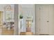 Hallway with a view of a dining area and front door that lets in natural light at 261 Palm St, Mount Pleasant, SC 29464