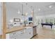 Open kitchen with a large island, stainless steel sink, and modern appliances at 261 Palm St, Mount Pleasant, SC 29464