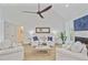 Comfortable living area with a vaulted ceiling, fireplace, and soothing color palette at 261 Palm St, Mount Pleasant, SC 29464