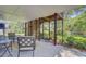 Relaxing patio area featuring comfortable seating and a view of the fenced yard and lush greenery at 261 Palm St, Mount Pleasant, SC 29464