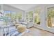 Inviting sunroom with large windows, comfortable seating, and a calming view at 261 Palm St, Mount Pleasant, SC 29464