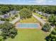 Aerial view of a tennis court near a playground surrounded by mature trees at 261 Palm St, Mount Pleasant, SC 29464