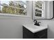 Modern bathroom sink with black faucet, mirror, and natural light at 267 Industrial Rd, Walterboro, SC 29488