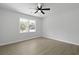 Bright bedroom featuring neutral walls, ceiling fan, and large windows with ample natural light at 267 Industrial Rd, Walterboro, SC 29488
