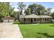 Classic brick home with detached garage featuring a green lawn and traditional design elements at 267 Industrial Rd, Walterboro, SC 29488