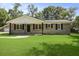 Charming brick home with a well-manicured lawn and symmetrical window design under a bright, sunny sky at 267 Industrial Rd, Walterboro, SC 29488