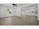 Bright, airy living room with new flooring, fresh white paint, and modern ceiling fan at 267 Industrial Rd, Walterboro, SC 29488