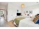Comfortable bedroom features a white bed with rattan accents, neutral walls and views into the adjacent living spaces at 2815 Colonel Harrison Drive Dr, Johns Island, SC 29455