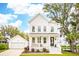 Charming two-story home with white siding, a welcoming front porch, and lush landscaping at 2815 Colonel Harrison Drive Dr, Johns Island, SC 29455