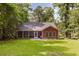 Exterior of a home with a screened in patio, grill, and lush lawn at 2941 Murraywood Rd, Johns Island, SC 29455