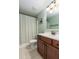 Cozy bathroom with tiled floors, wooden vanity and framed mirror, and shower with patterned curtain at 2941 Murraywood Rd, Johns Island, SC 29455