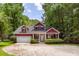 Charming two-story red home featuring a well-manicured lawn and an attached garage at 2941 Murraywood Rd, Johns Island, SC 29455