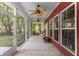 Spacious screened patio with ceiling fans, outdoor seating, and view of wooded backyard at 2941 Murraywood Rd, Johns Island, SC 29455
