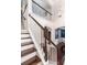 Elegant staircase with white railings and dark wood steps, leading to a second-story landing at 2941 Murraywood Rd, Johns Island, SC 29455